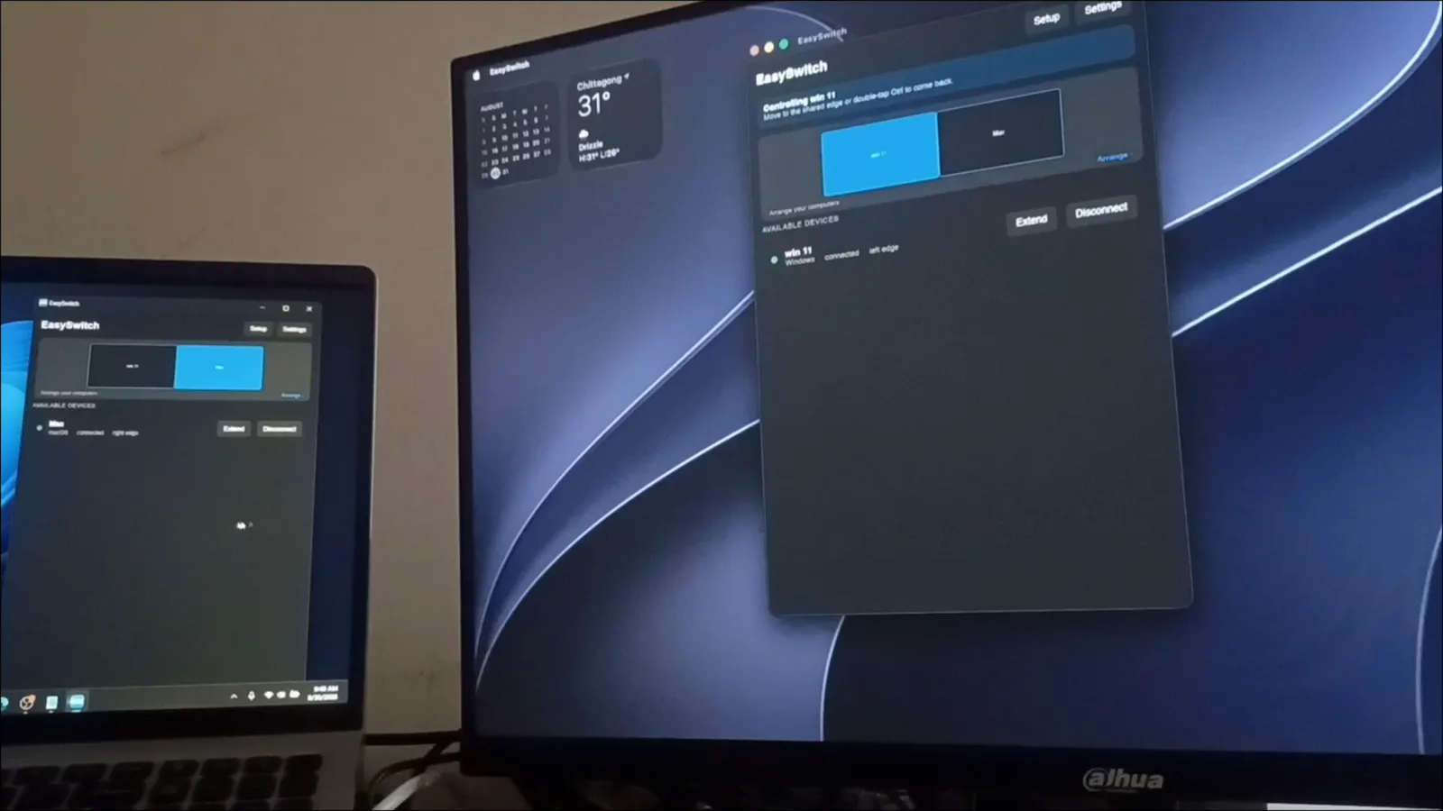 A MacBook and a Windows PC side by side on a desk, the EasySwitch window open on both screens.